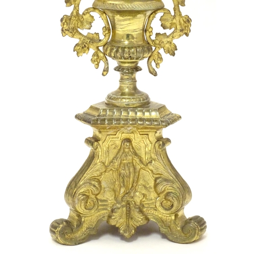 1031 - A 20thC large ecclesiastical gilded pricket candlestick with a fluted column flanked by applied vine... 