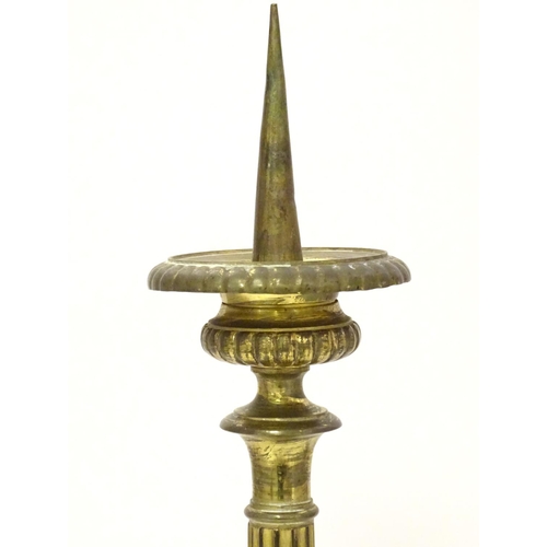 1031 - A 20thC large ecclesiastical gilded pricket candlestick with a fluted column flanked by applied vine... 