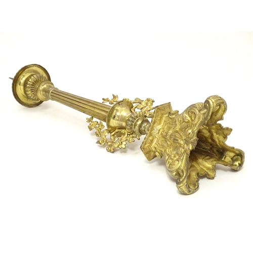 1031 - A 20thC large ecclesiastical gilded pricket candlestick with a fluted column flanked by applied vine... 