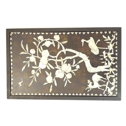 1044A - A 20thC Chinese hardwood panel with mother of pearl inlay depicting a stylised woodland scene with a... 