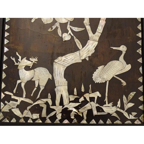 1044A - A 20thC Chinese hardwood panel with mother of pearl inlay depicting a stylised woodland scene with a... 