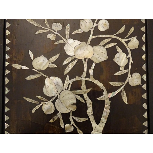 1044A - A 20thC Chinese hardwood panel with mother of pearl inlay depicting a stylised woodland scene with a... 