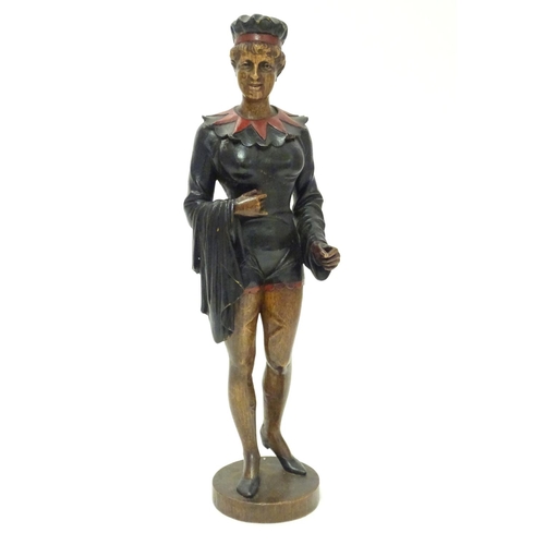 1049 - A 20thC carved wooden sculpture modelled as a woman wearing a jester style outfit with polychrome de... 