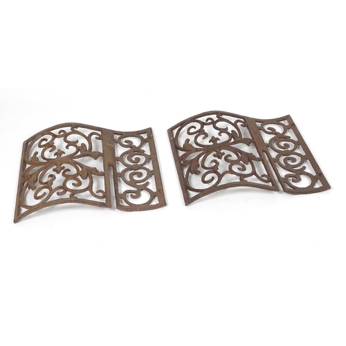 1057 - Two wrought iron architectural panels, of waved form, 16