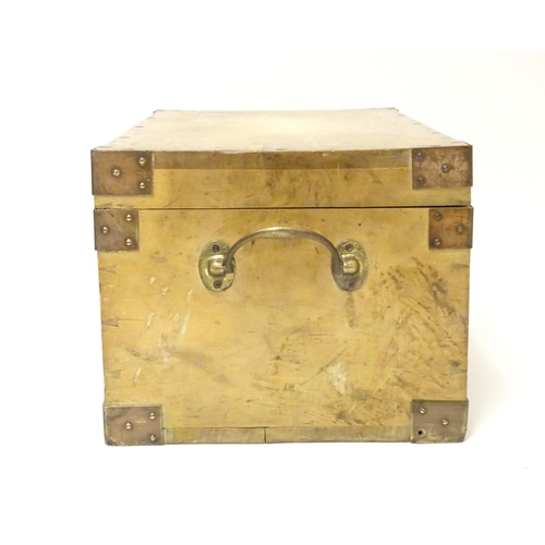 1078 - An early to mid 20thC hardwood box with brass carrying handles and brass mounts to the corners along... 