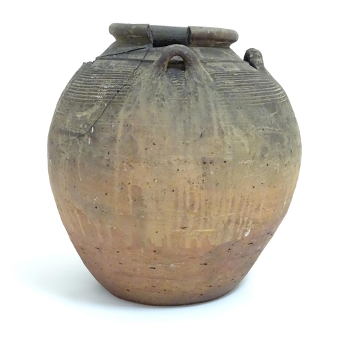 1086 - An antique clay pot / vase with loop handles and incised banded detail. Approx. 14 1/2