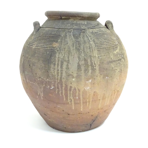 1086 - An antique clay pot / vase with loop handles and incised banded detail. Approx. 14 1/2