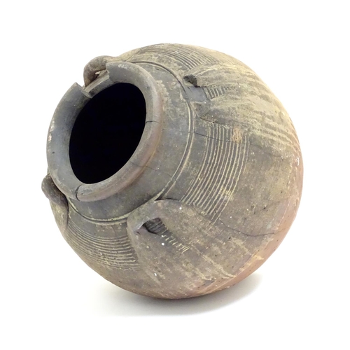 1086 - An antique clay pot / vase with loop handles and incised banded detail. Approx. 14 1/2