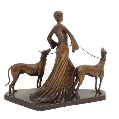 1088 - A 20thC bronze sculpture modelled as a lady walking two dogs. Approx. 17