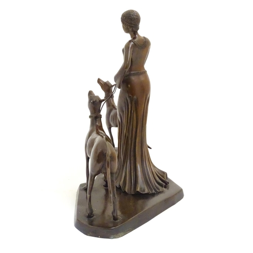 1088 - A 20thC bronze sculpture modelled as a lady walking two dogs. Approx. 17