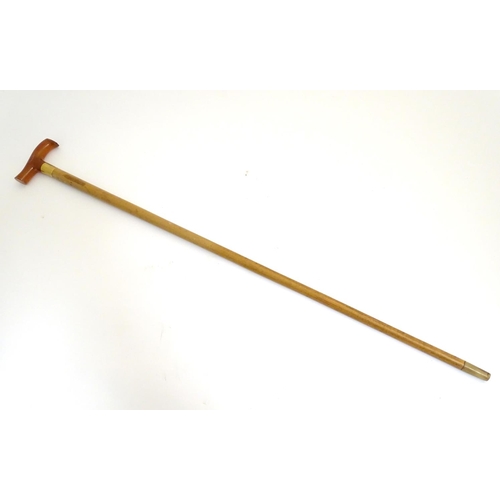 1093 - An early to mid-20thC Brigg walking stick, with 18ct gold band, amber Bakelite handle, malacca shaft... 