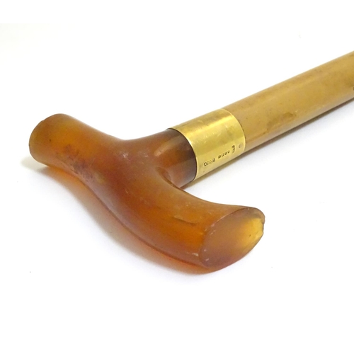 1093 - An early to mid-20thC Brigg walking stick, with 18ct gold band, amber Bakelite handle, malacca shaft... 