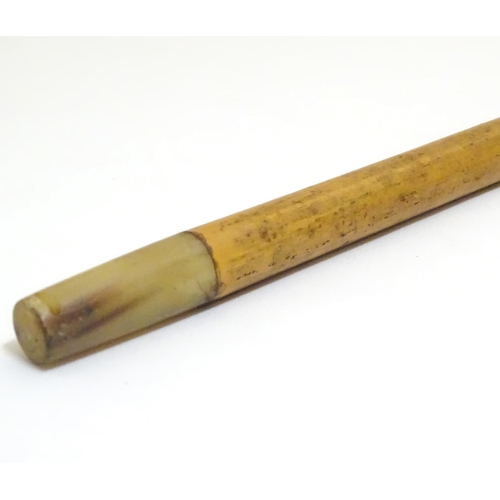 1093 - An early to mid-20thC Brigg walking stick, with 18ct gold band, amber Bakelite handle, malacca shaft... 