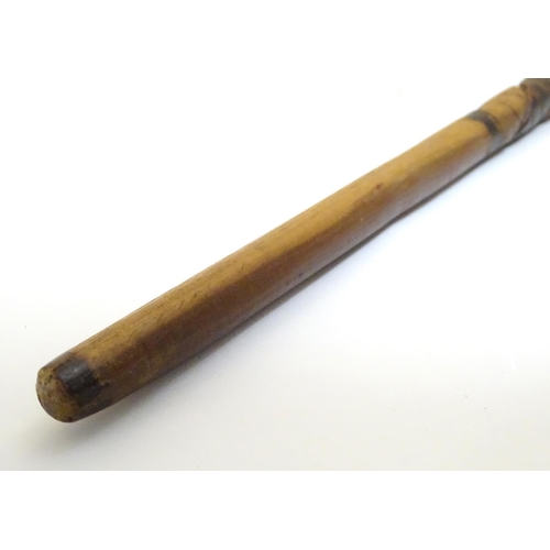 1094 - An early 20thC Australian blackwood walking cane, the knop formed as a clenched fist holding a snake... 