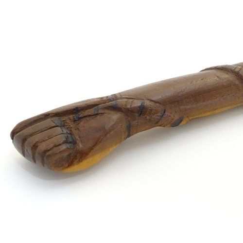 1094 - An early 20thC Australian blackwood walking cane, the knop formed as a clenched fist holding a snake... 