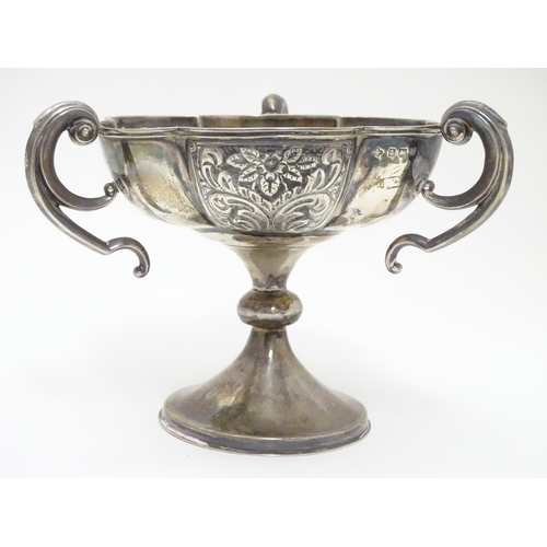 188 - A silver pedestal dish with three handles and embossed decoration. Hallmarked Birmingham 1906 maker ... 