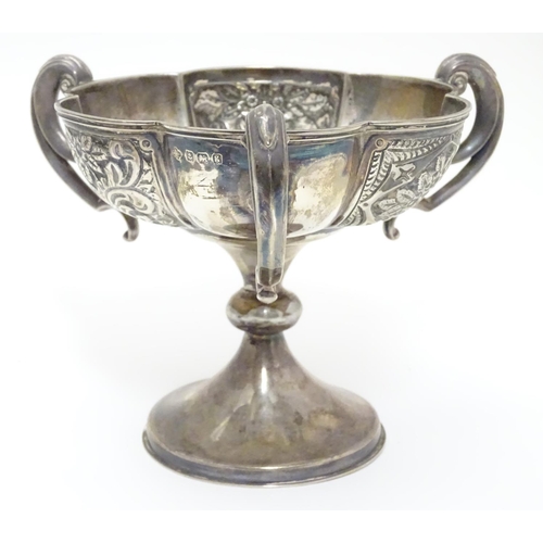 188 - A silver pedestal dish with three handles and embossed decoration. Hallmarked Birmingham 1906 maker ... 