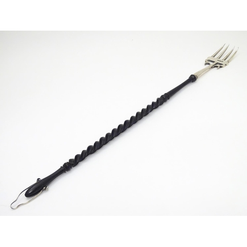 189 - A silver toasting fork with turned ebonised handle. The silver fork section hallmarked Chester 1903 ... 