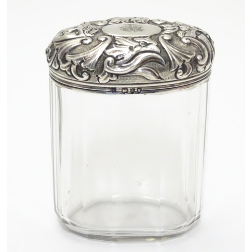 193 - A glass toilet bottle with silver lid hallmarked London 1893 maker Charles Henry Dumenil 3 1/5