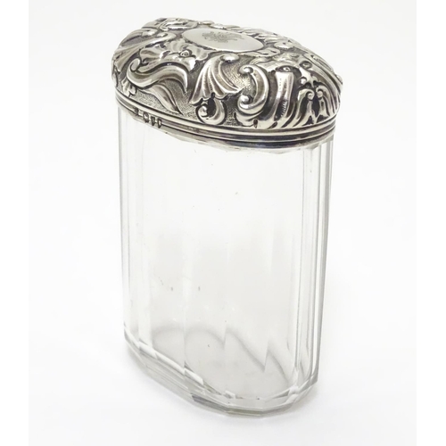 193 - A glass toilet bottle with silver lid hallmarked London 1893 maker Charles Henry Dumenil 3 1/5