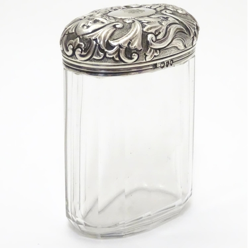 193 - A glass toilet bottle with silver lid hallmarked London 1893 maker Charles Henry Dumenil 3 1/5