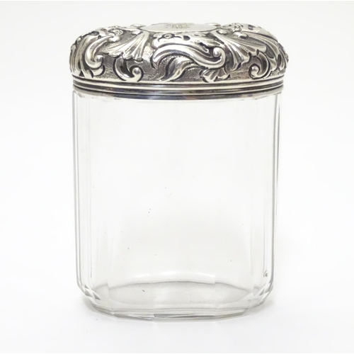 193 - A glass toilet bottle with silver lid hallmarked London 1893 maker Charles Henry Dumenil 3 1/5