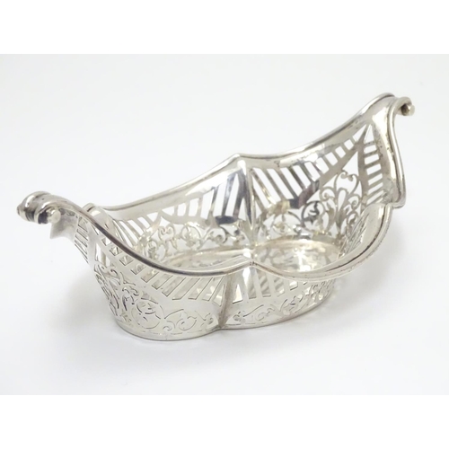 194 - A Silver boat-shaped dish with scroll ends and pierced decoration. Bears a small yacht style mark un... 