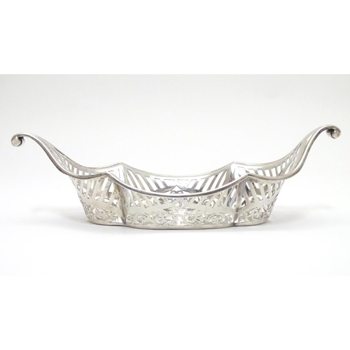 194 - A Silver boat-shaped dish with scroll ends and pierced decoration. Bears a small yacht style mark un... 