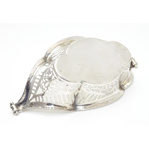 194 - A Silver boat-shaped dish with scroll ends and pierced decoration. Bears a small yacht style mark un... 