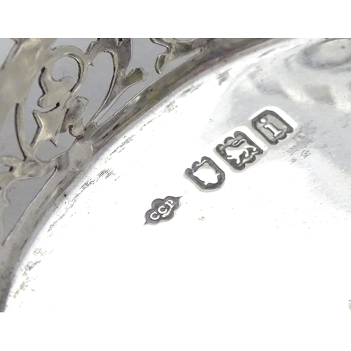 194 - A Silver boat-shaped dish with scroll ends and pierced decoration. Bears a small yacht style mark un... 