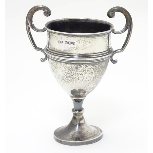 200 - A silver pedestal trophy cup with twin handles. hallmarked Sheffield 1935 maker James Edward Barry. ... 