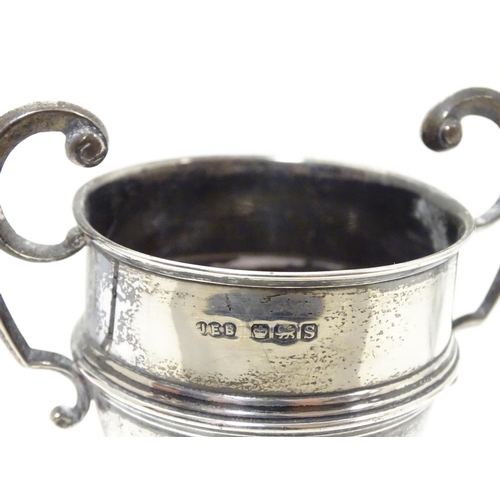 200 - A silver pedestal trophy cup with twin handles. hallmarked Sheffield 1935 maker James Edward Barry. ... 