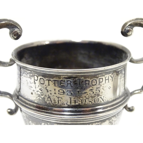 200 - A silver pedestal trophy cup with twin handles. hallmarked Sheffield 1935 maker James Edward Barry. ... 