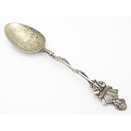 290 - A silver souvenir spoon, the leaf surrounded handle surmounted by a bust of William Shakespeare over... 