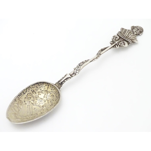 290 - A silver souvenir spoon, the leaf surrounded handle surmounted by a bust of William Shakespeare over... 