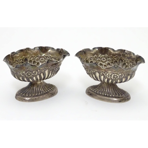 296 - A pair of Victorian silver table salts with fluted decoration and wavy rims, raised on oval pedestal... 