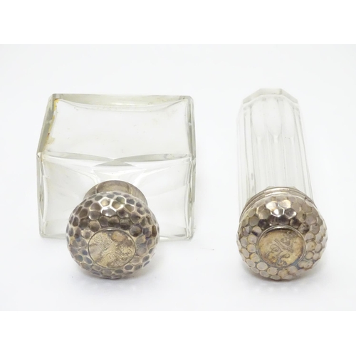 306 - A silver lidded glass scent bottle and a matching silver lidded glass vanity bottle, both lids with ... 