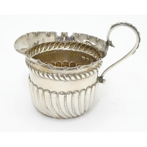 308 - A Victorian silver cream jug with fluted decoration. Hallmarked Birmingham 1891 maker Vale Brothers ... 