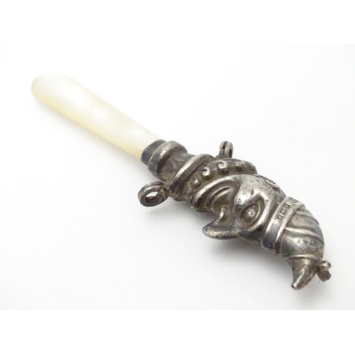 310 - A child's rattle with mother of pearl teether and silver Mr Punch decoration. Hallmarked Birmingham ... 