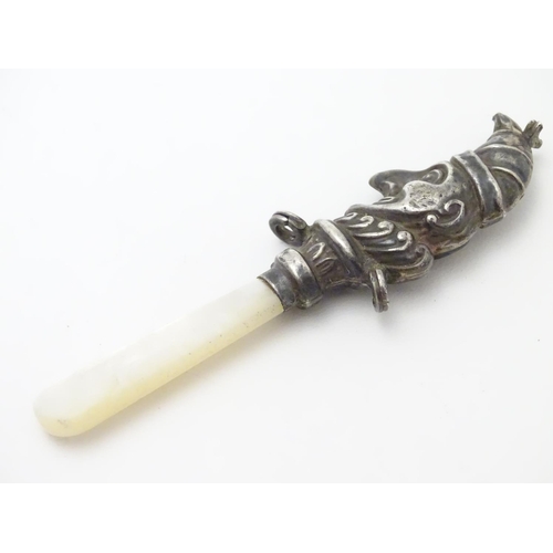 310 - A child's rattle with mother of pearl teether and silver Mr Punch decoration. Hallmarked Birmingham ... 