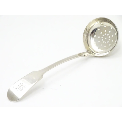 318 - A Victorian Scottish silver fiddle pattern sifting ladle. Hallmarked Edinburgh 1841 maker Mackay & C... 