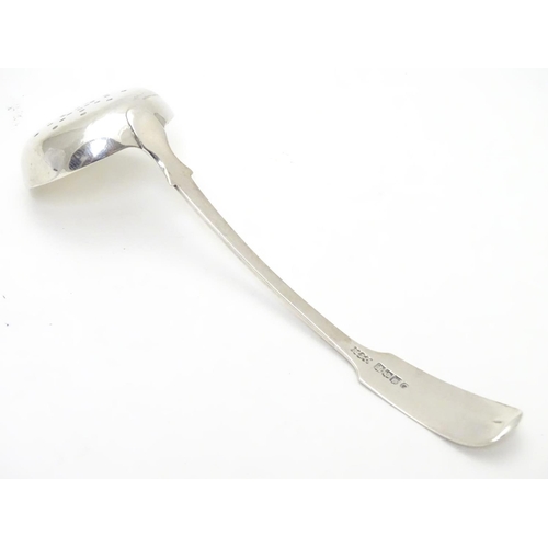 318 - A Victorian Scottish silver fiddle pattern sifting ladle. Hallmarked Edinburgh 1841 maker Mackay & C... 