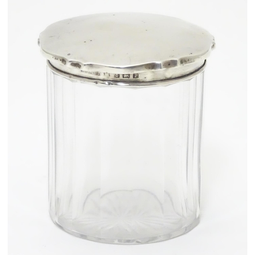 319 - A glass jar with silver lid hallmarked Birmingham 1914 3 1/4