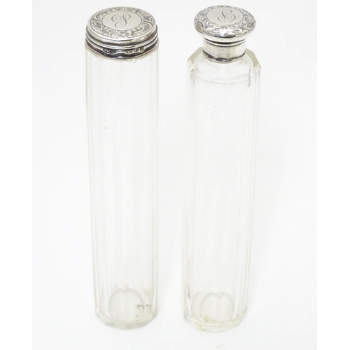 329 - Two glass dressing table bottles with silver tops hallmarked London 1895. The tallest 7