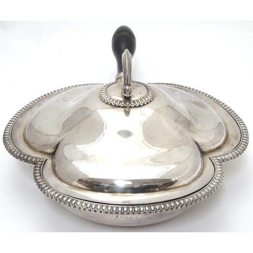 425 - A silver plate serving dish and cover of trefoil form with three sections within and having ebonised... 