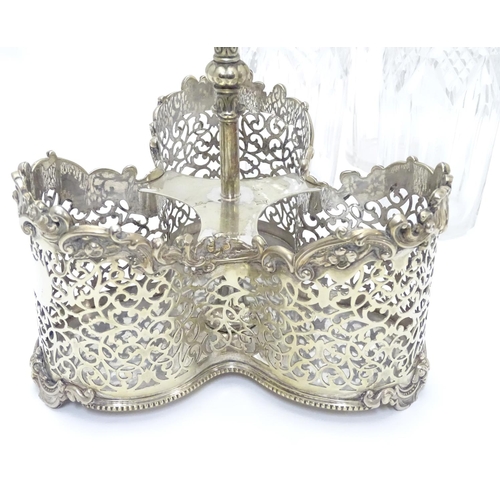 426 - A Victorian silver plate tantalus / bottle stand with three cut glass decanters. The whole approx 19... 