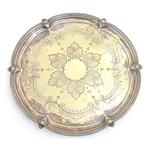 433 - A silver plate salver with engraved decoration. Approx 15