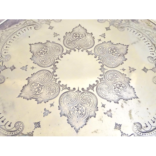 433 - A silver plate salver with engraved decoration. Approx 15