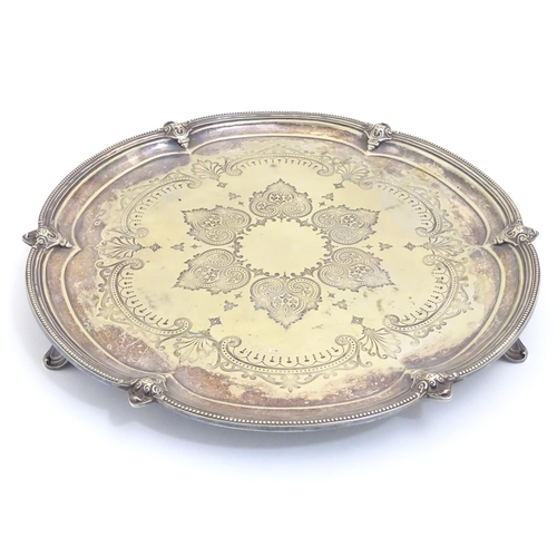 433 - A silver plate salver with engraved decoration. Approx 15