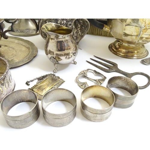 433A - A large equanimity of assorted silver plated wares to include candlesticks, flatware, serving dishes... 